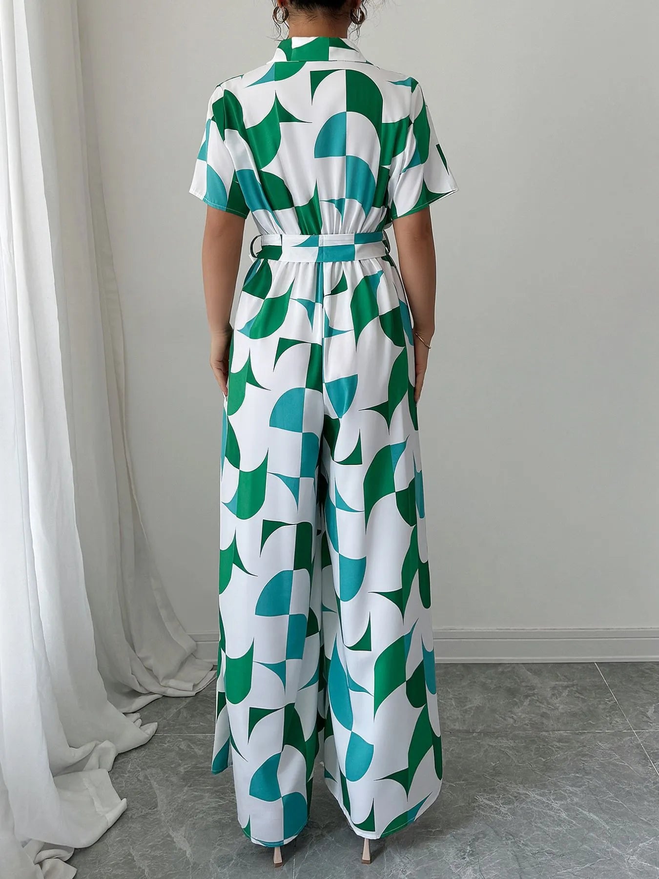 Green and turquoise geometric belted wide-leg jumpsuit, back view, short sleeves