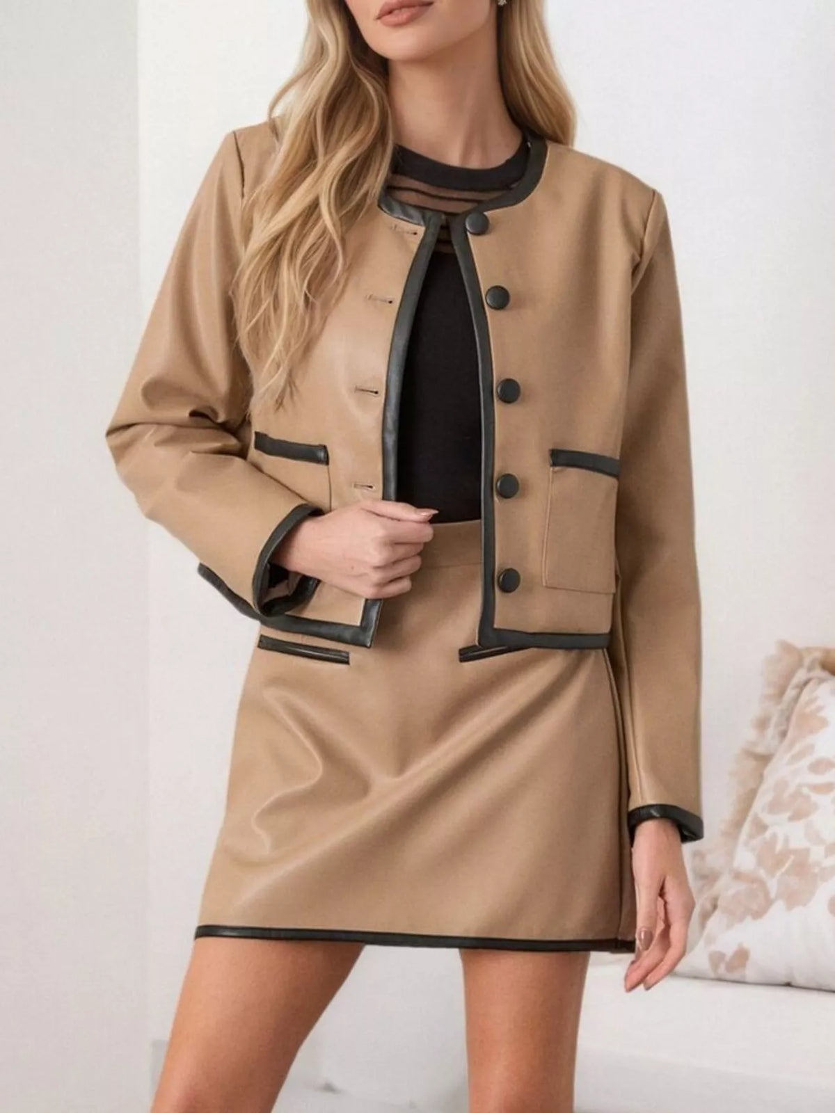 Tan contrast-trim jacket and matching mini skirt set, black piping and button details