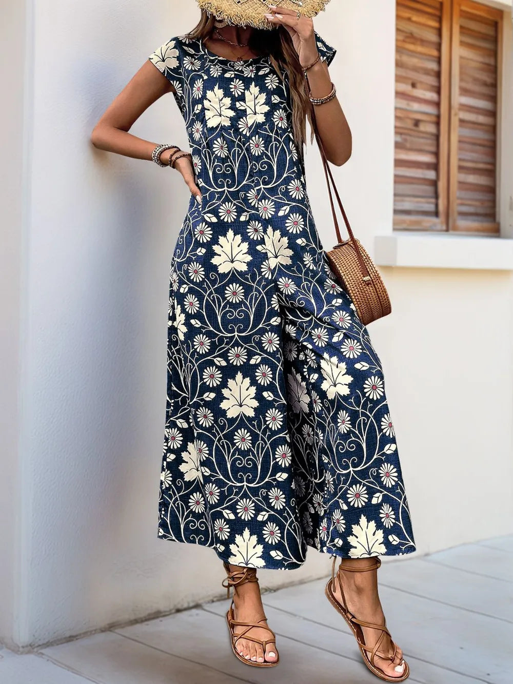 Navy floral printed wide-leg jumpsuit with round neck and cap sleeves, back view