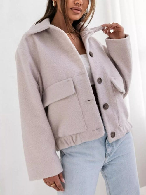 Light gray button-down long-sleeve outerwear jacket with snap front and chest flap pockets