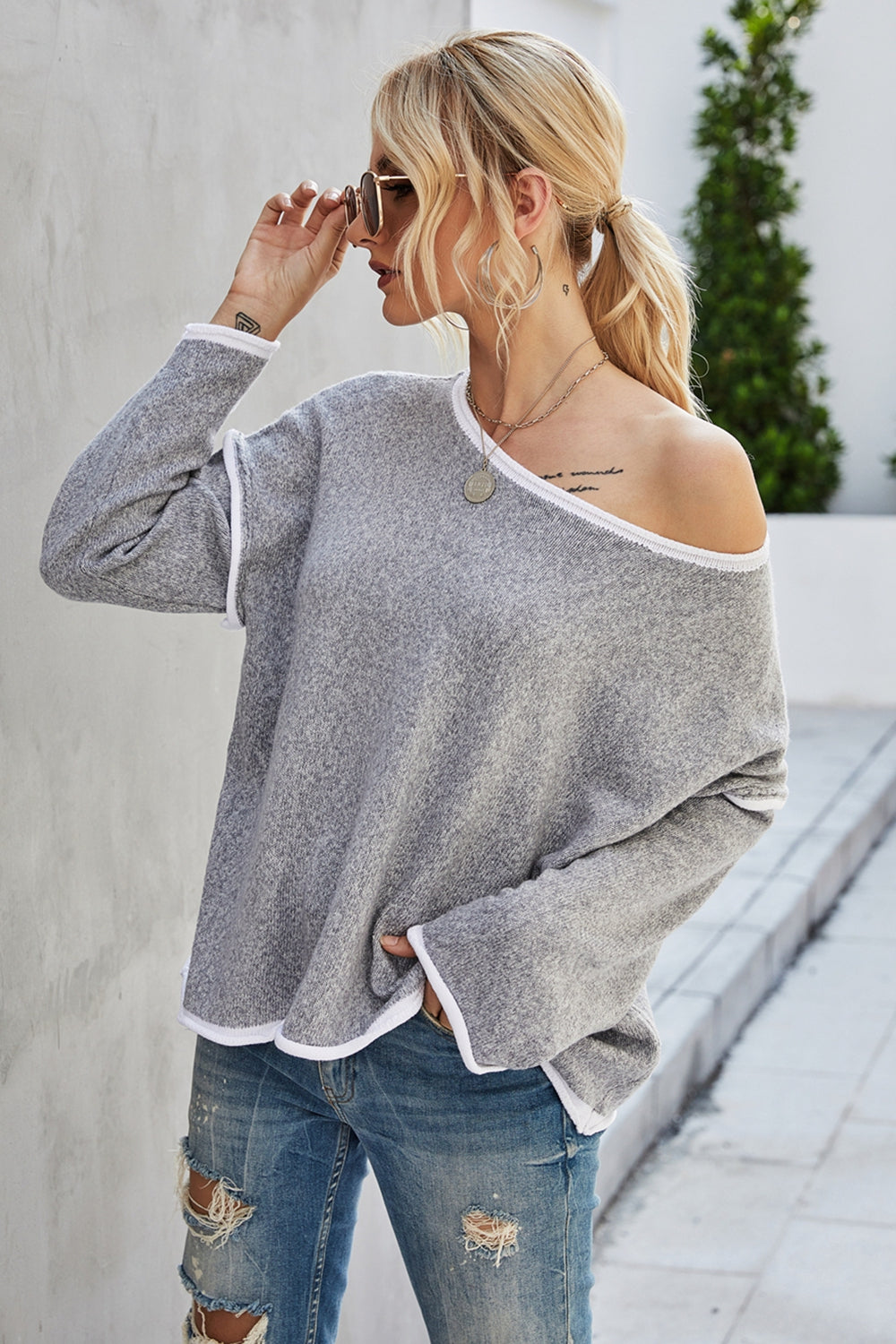 Cloudy blue dropped-shoulder sweater with round neck and white contrast trim, back view
