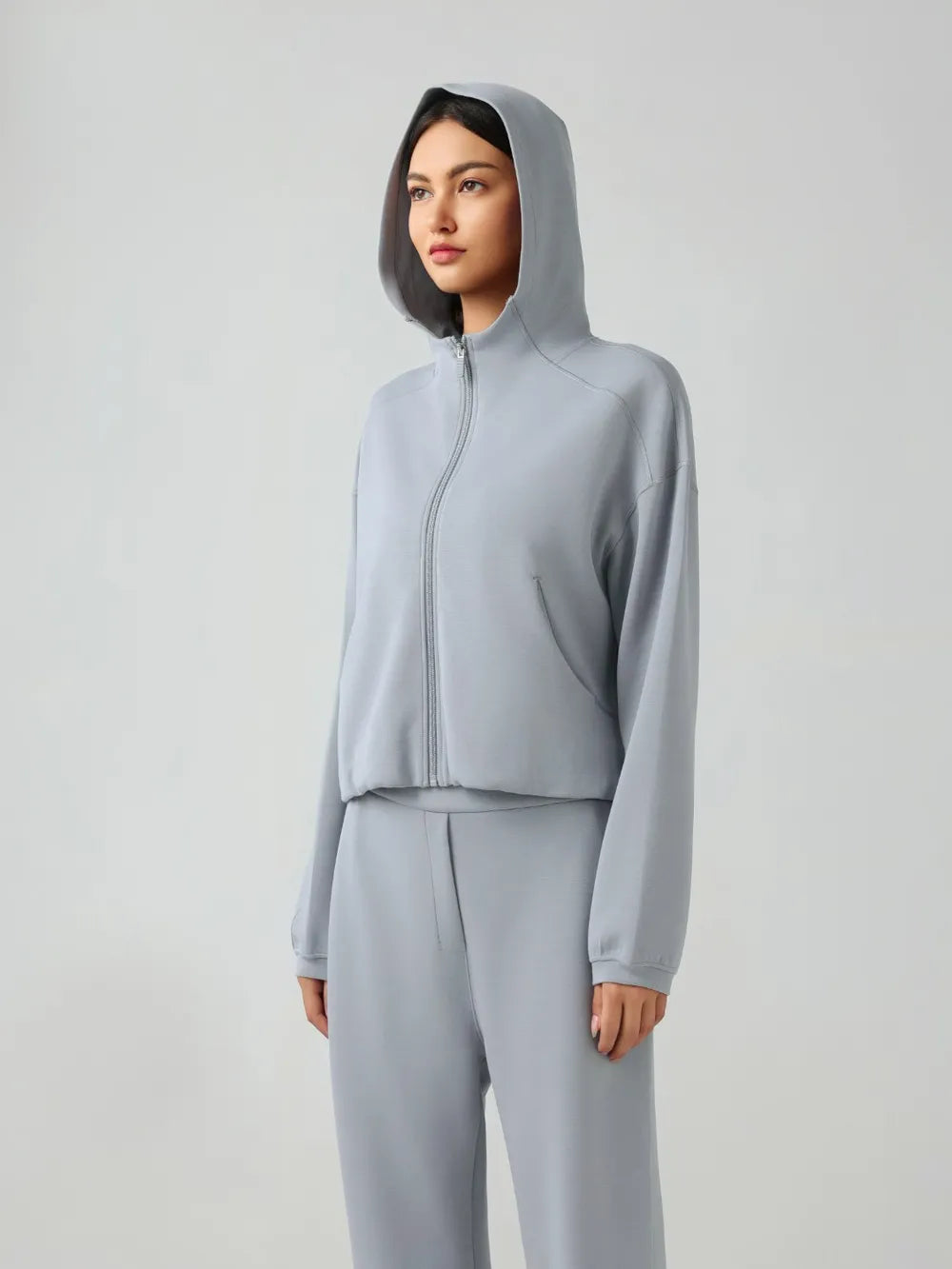 Light blue zip-up active hoodie with hood, full front zipper, and relaxed dropped-shoulder fit