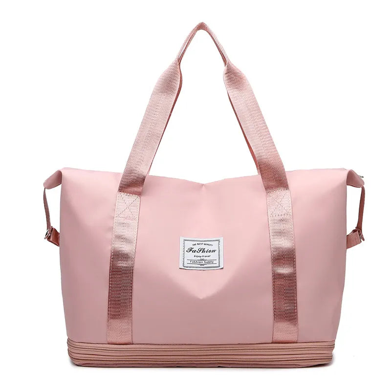 Large pink duffle travel bag with shoulder handles and front pocket