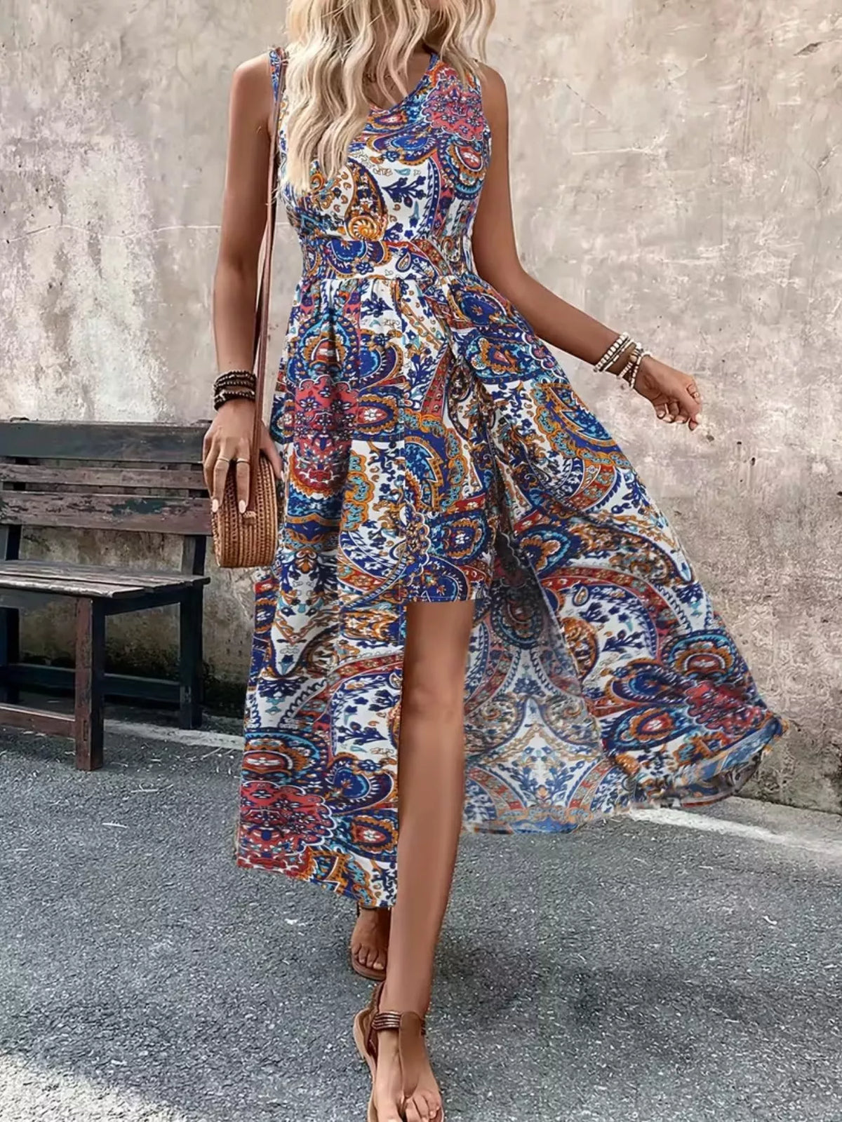 Sleeveless paisley print romper, blue base with red and gold accents, front split
