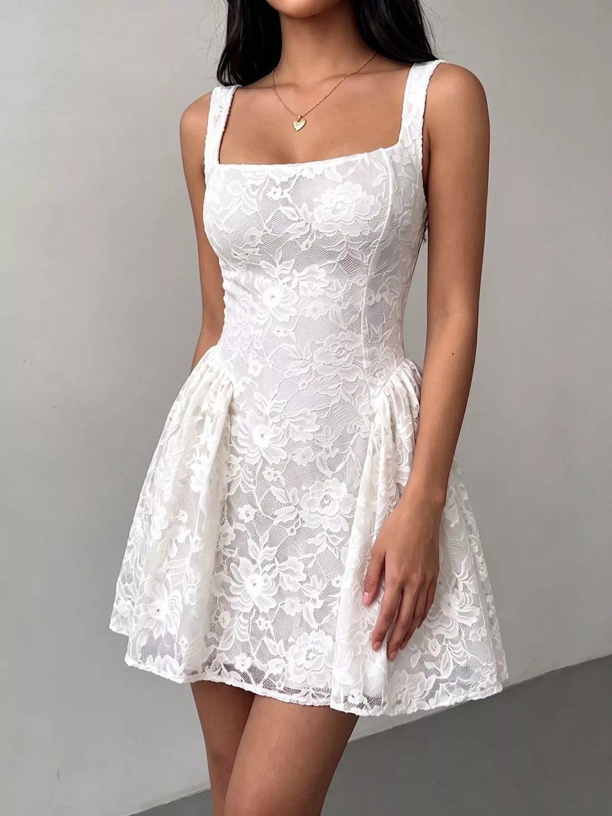 White lace square-neck sleeveless dress with full skirt and floral overlay