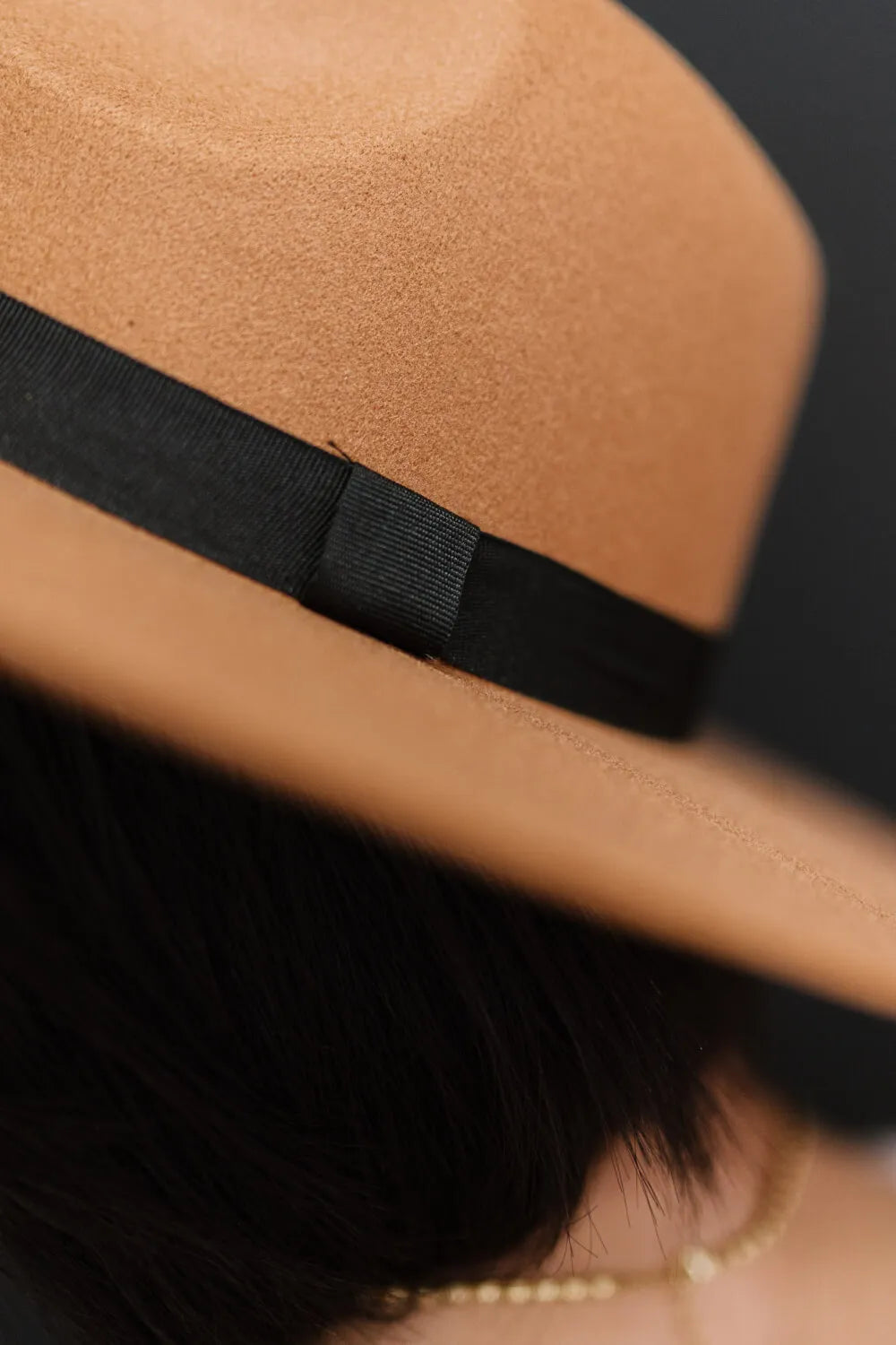 Close-up of khaki fedora hat black ribbon band