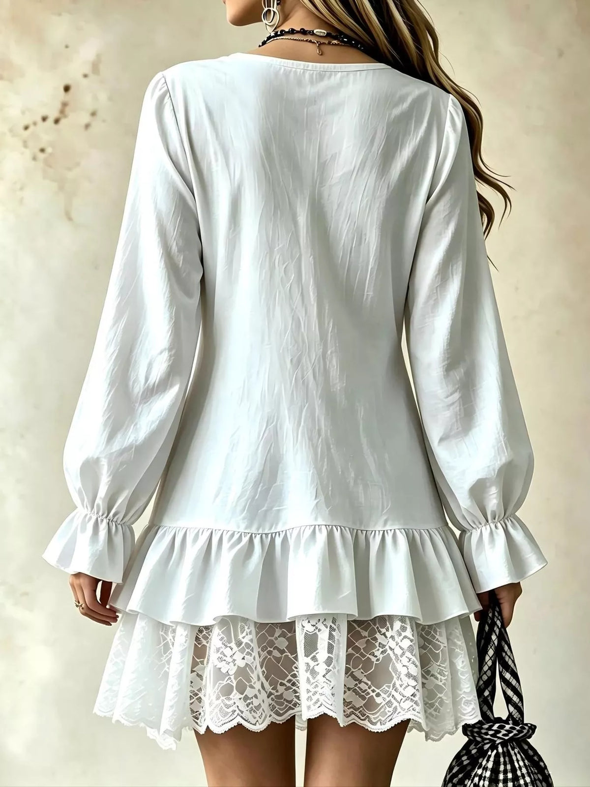 White V-neck lace hem dress, back view with long puff sleeves and ruffle hem