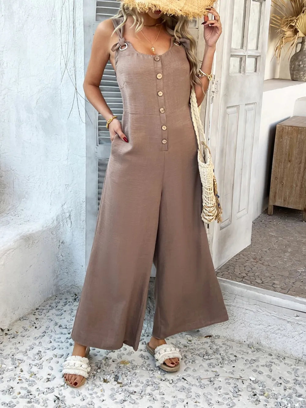 Taupe wide-leg jumpsuit with vertical button detail and knotted straps