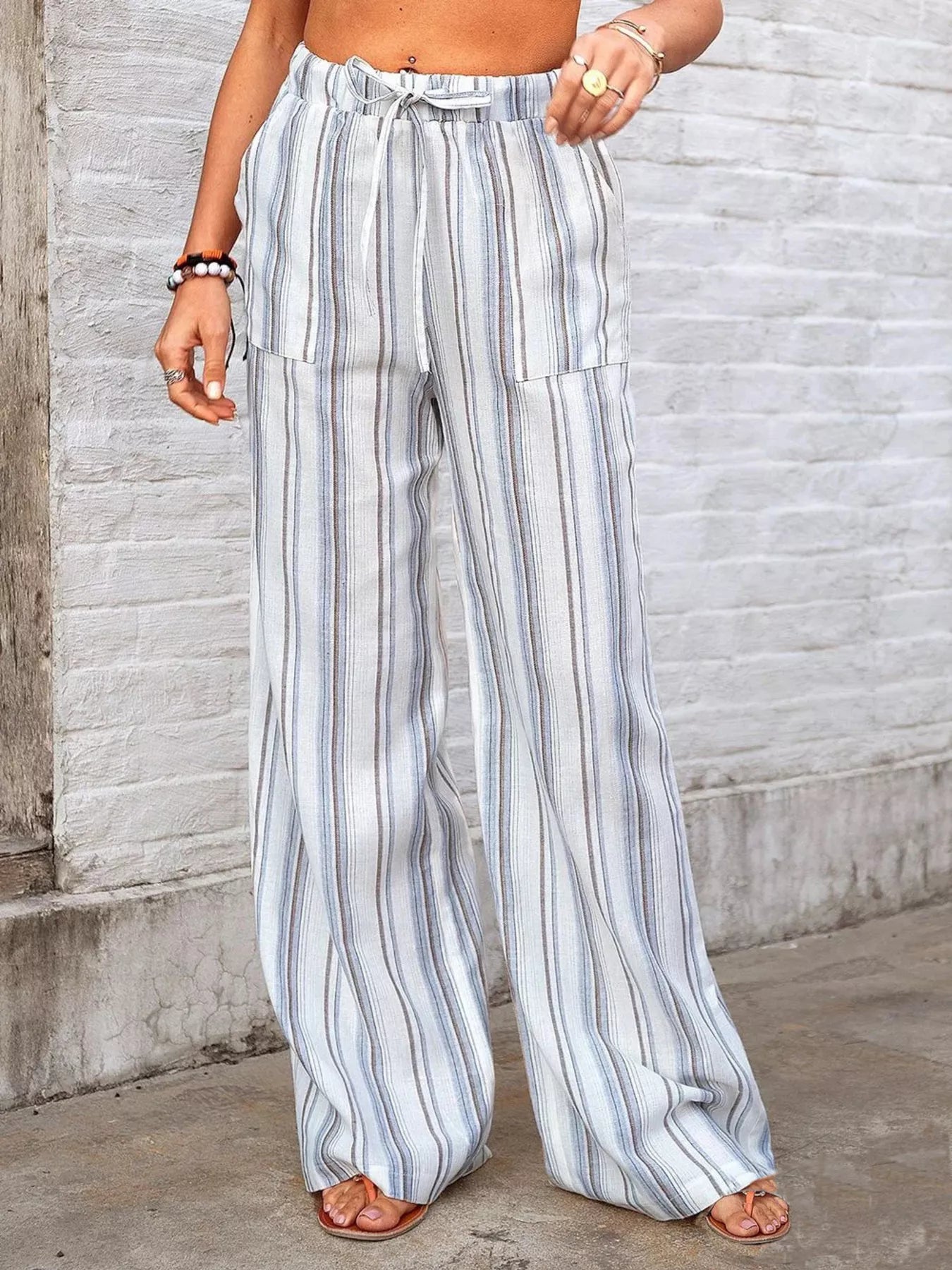 Light blue striped wide-leg pants with elastic waistband, drawstring, and side pockets