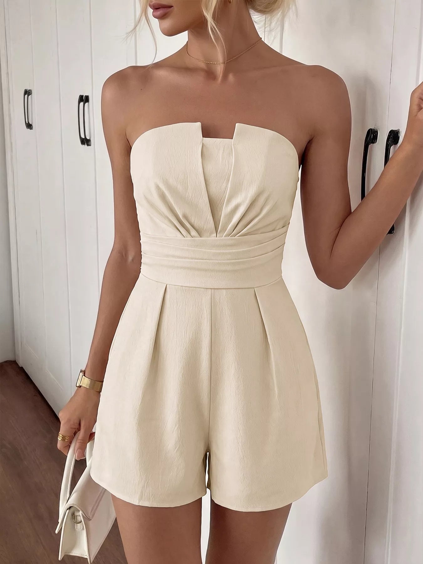 Cedar & Moore Strapless Pleated Detail Romper in cream by Trendsi, with a structured bodice and wide waistband shorts.