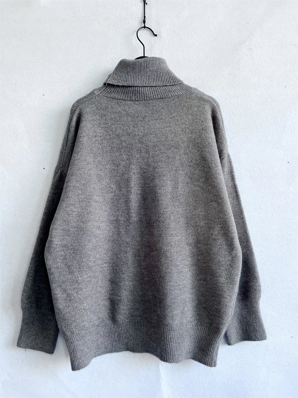 Turtleneck long-sleeve sweater in gray, ribbed turtleneck collar and cuffs.