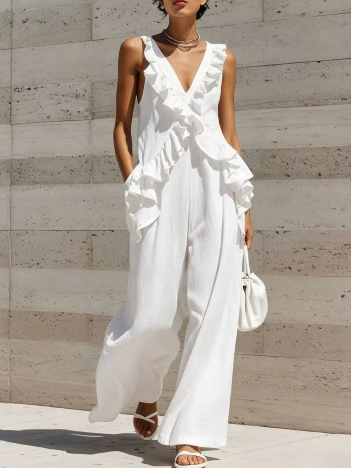 White ruffled V-neck sleeveless jumpsuit with layered ruffle front and wide-leg pants