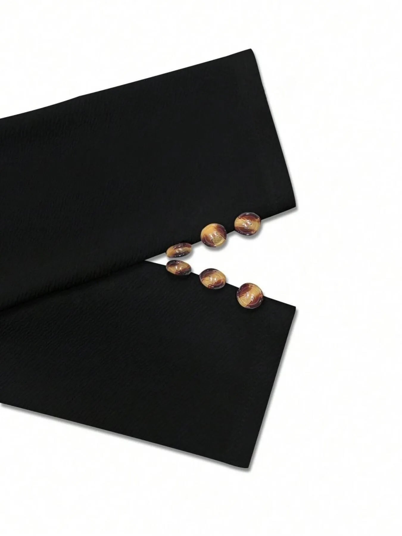 Black blazer cuff with gold-tone buttons