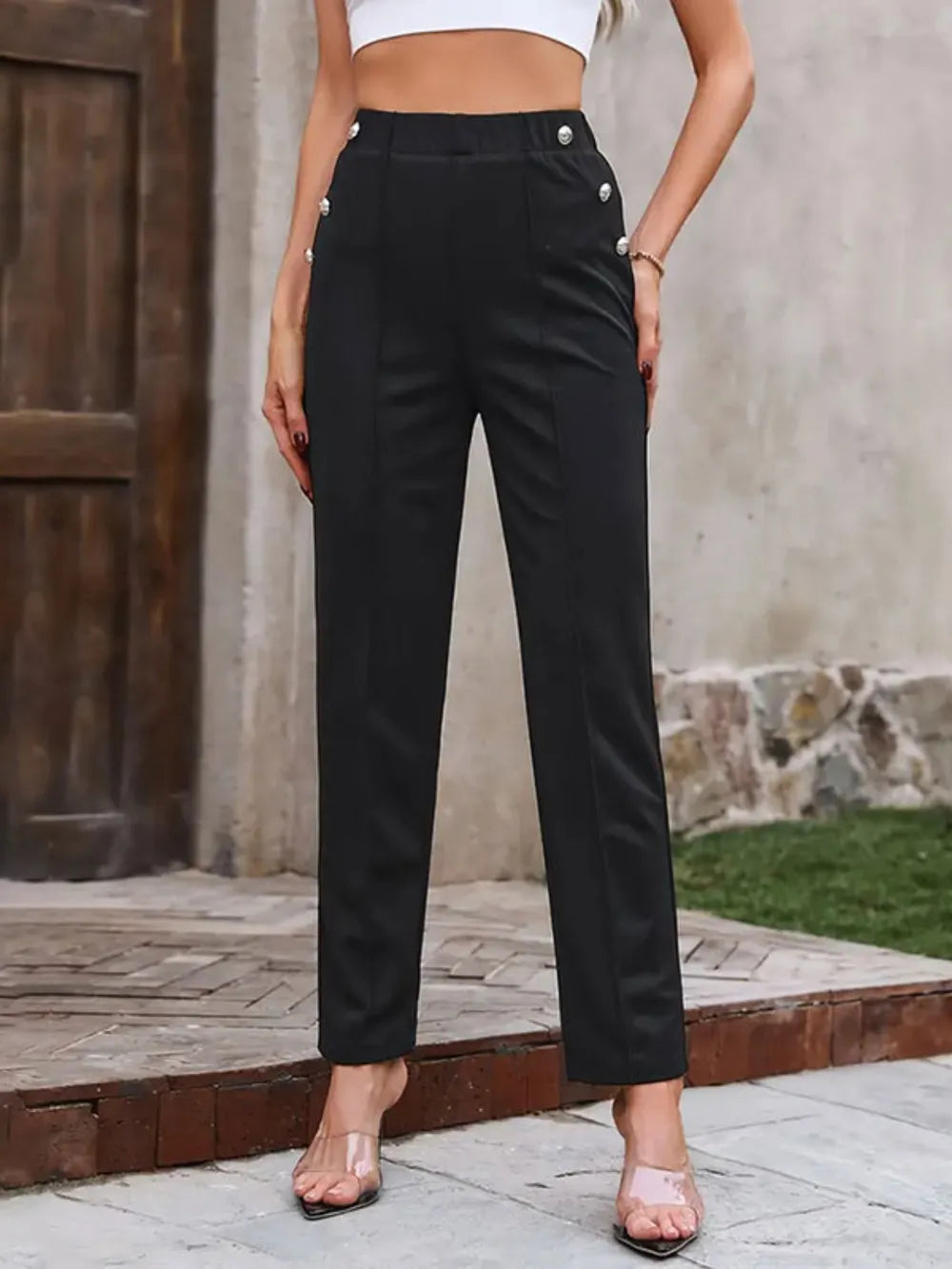 Black elastic-waist pants with buttoned waistband detail, slim straight legs