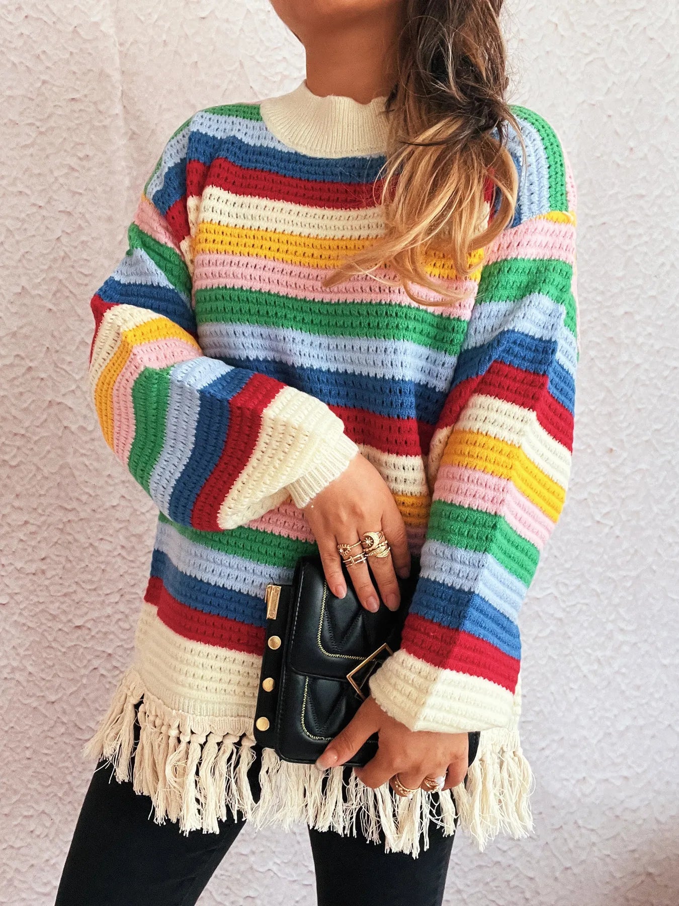 Rainbow striped long sleeve sweater with cream cuffs and tassel fringe hem