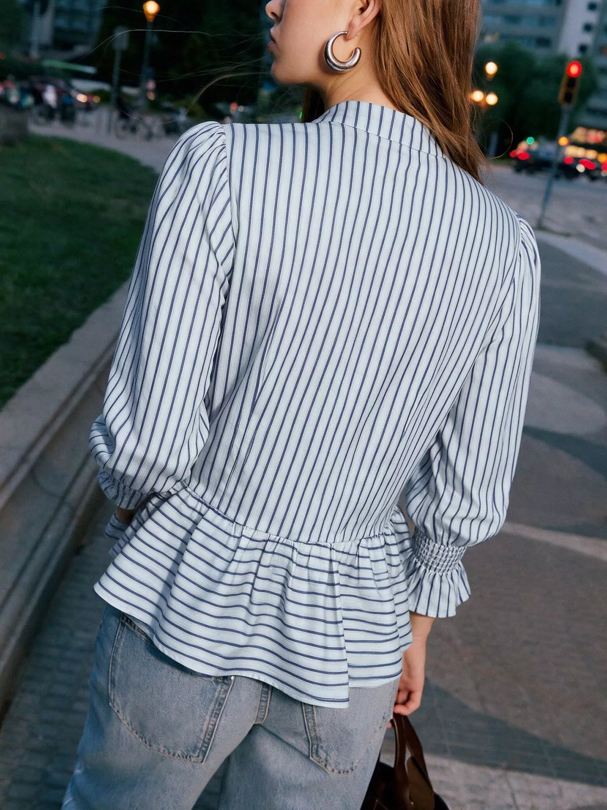Womens striped mandarin peplum knot shirt back view with gathered peplum and cuff ruffles