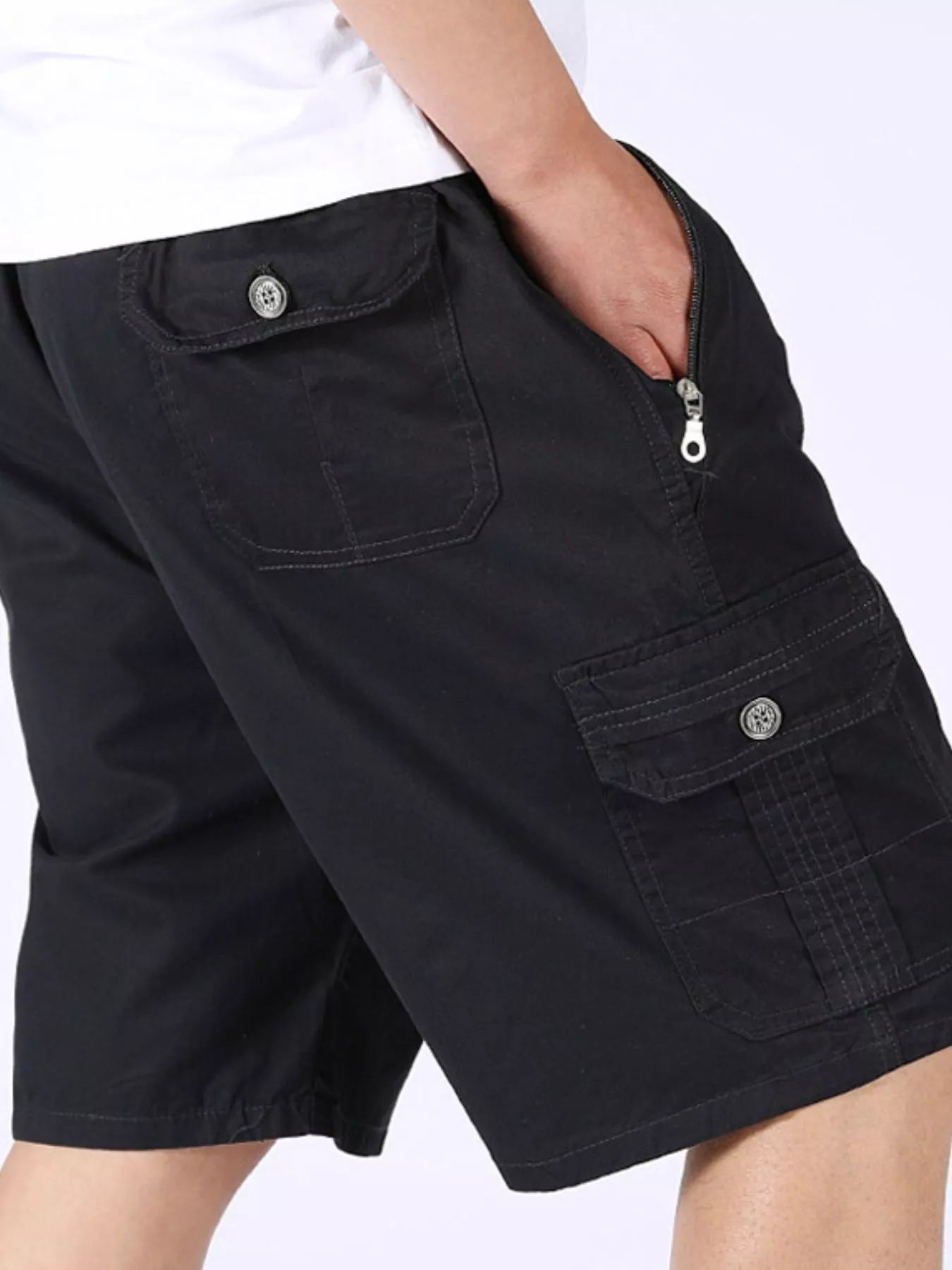 Black cargo shorts with flap cargo pocket and buttoned trim.