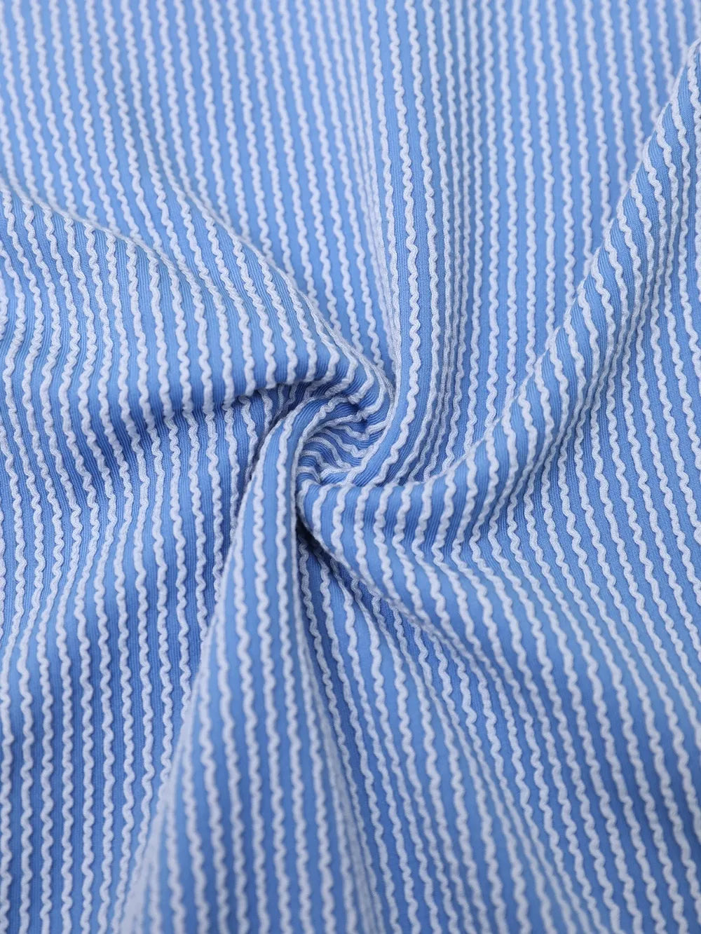 Blue textured seersucker-style fabric with thin vertical stripes