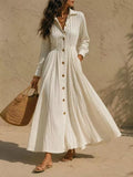 Cream maxi button-front shirtdress with textured fabric, long sleeves, and gathered waist