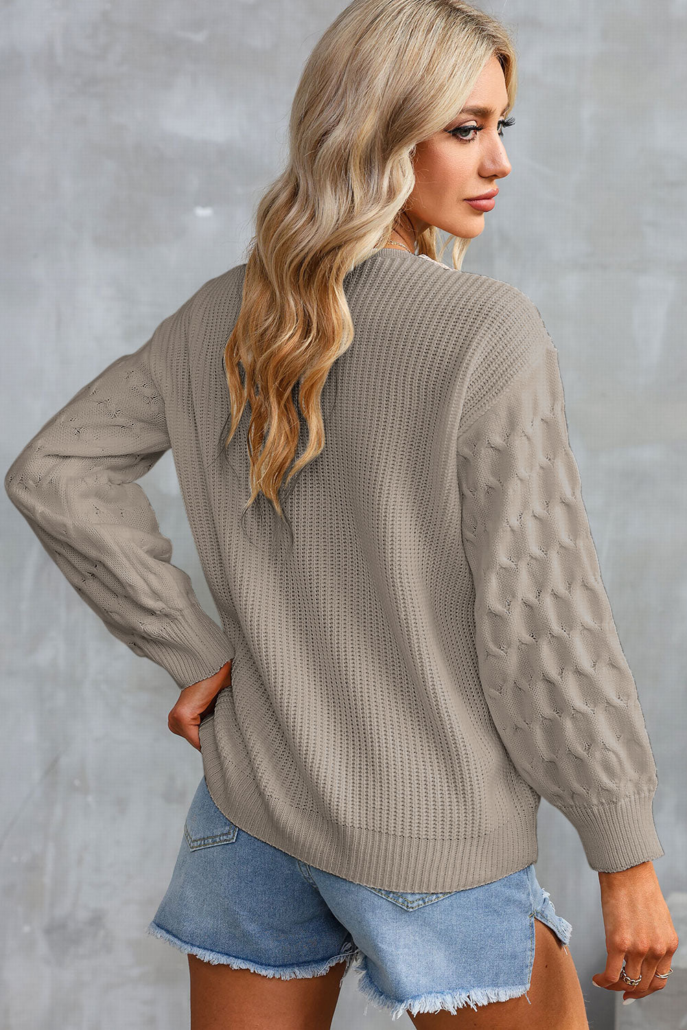 Khaki V-neck sweater with cream contrast trim and textured sleeve panels