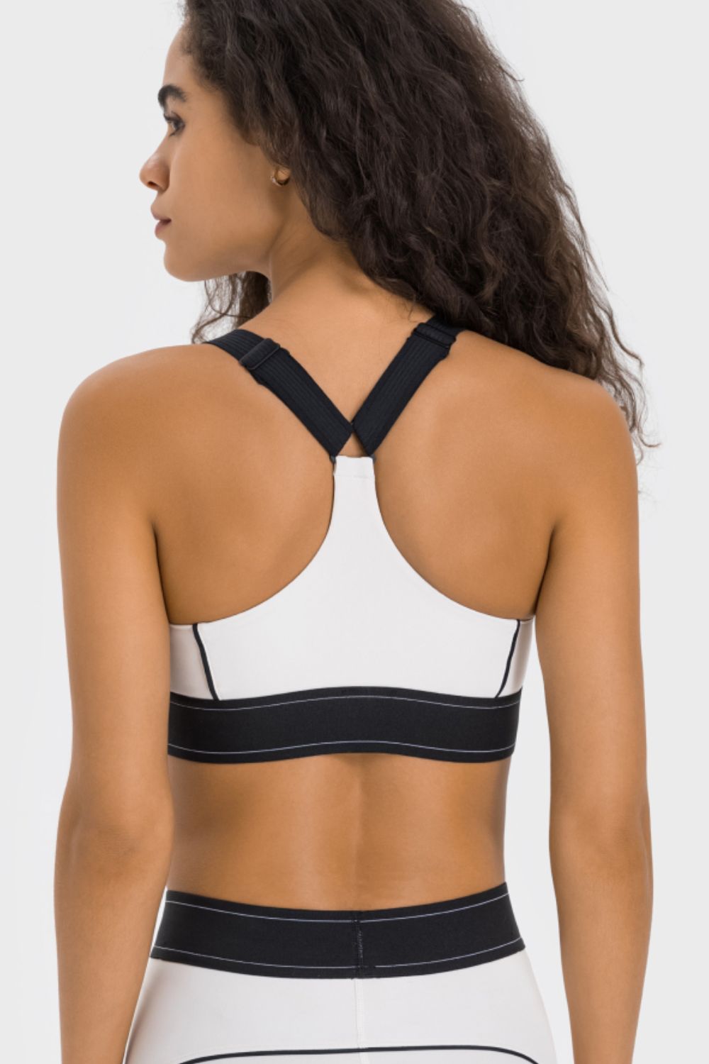 White contrast sports bra back view with crisscross straps and black trim