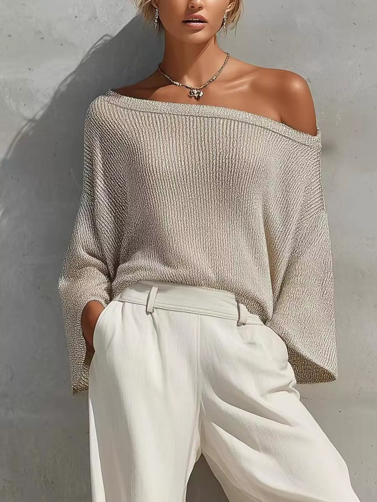 Gray off-shoulder knit top with high-waisted white jogger pants and elastic cuffs