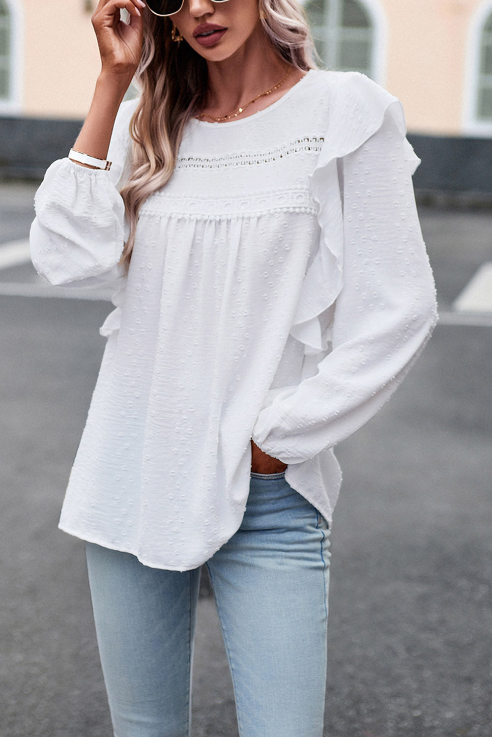 Ruffled round-neck blouse in white with long sleeves and tiered peplum-style front