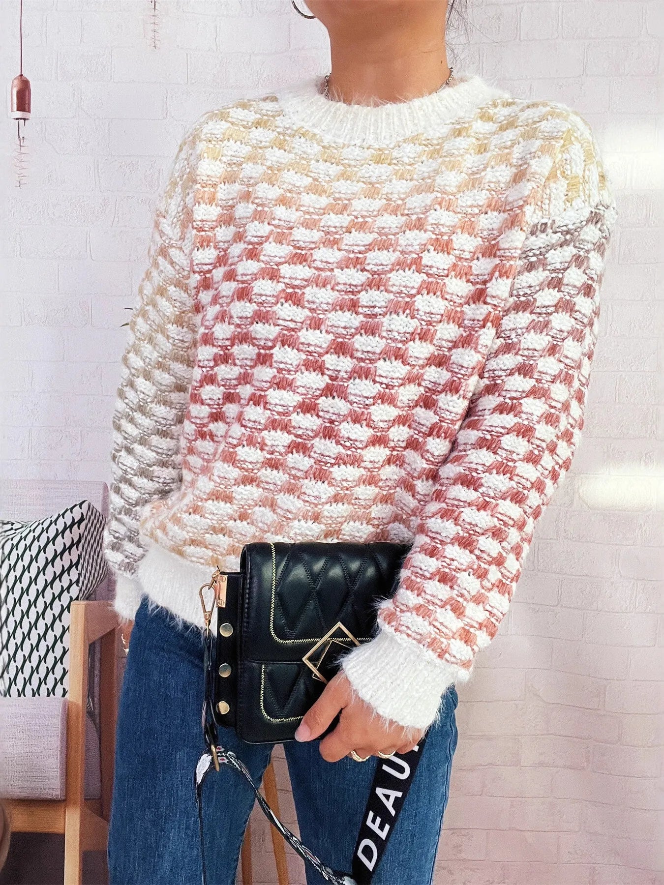Textured cream round-neck sweater with long sleeves, red and gold knit pattern