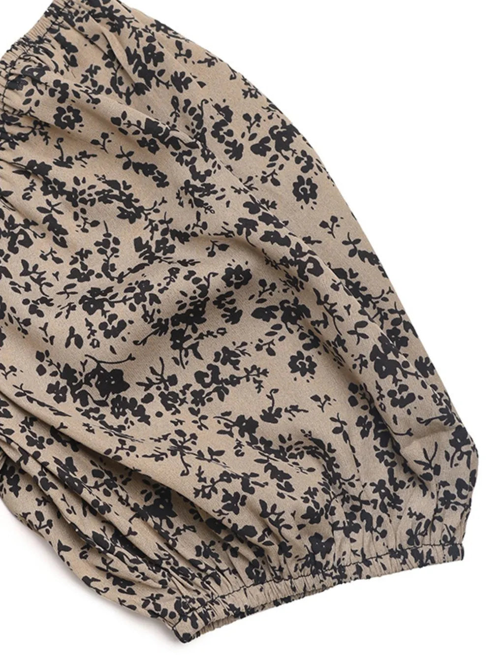 Taupe fabric swatch with navy floral micro-print and gathered cuff detail