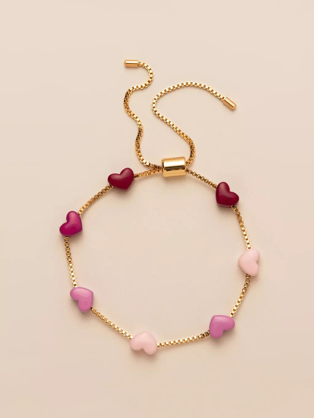 Gold heart charm adjustable bracelet with pink and dark pink heart beads