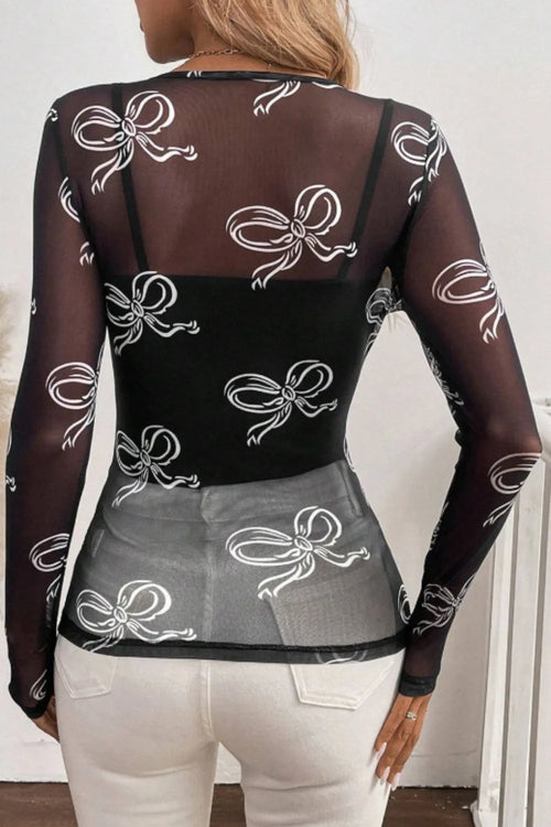 Black sheer long-sleeve top with white bow pattern, back view