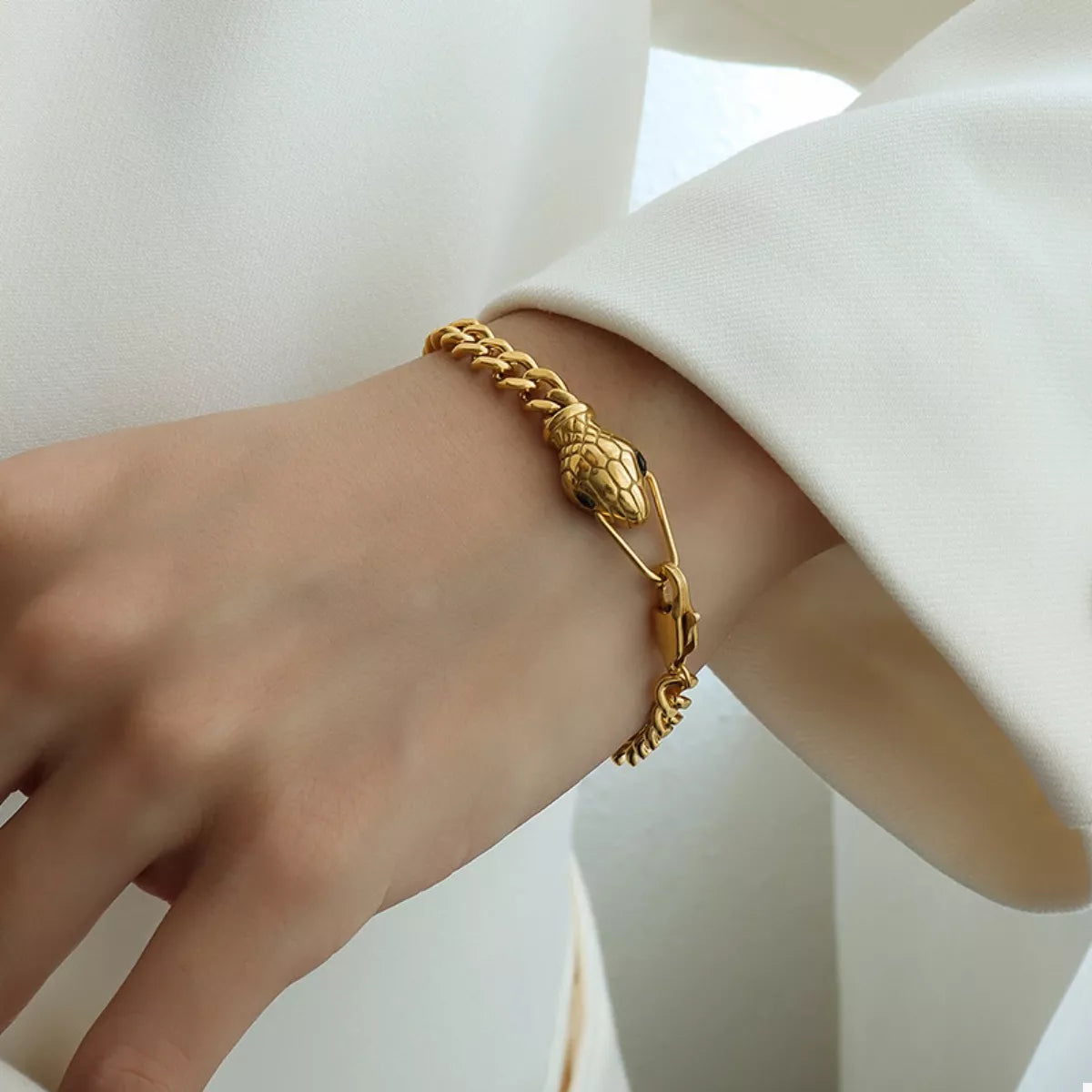 Gold snake charm chain bracelet with textured center link