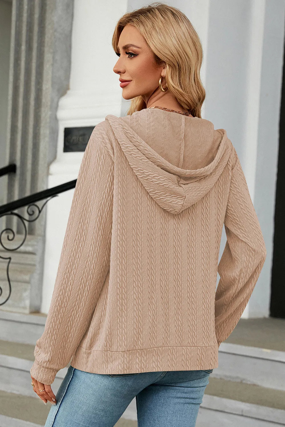 Cream zip-up hoodie with drawstring hood, showing back view and long sleeves