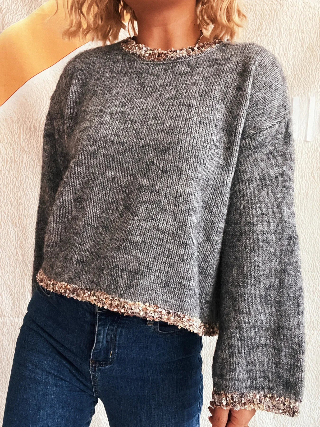 Dark gray cropped round-neck sweater with sparkling rose-gold trim at hem and cuffs