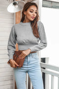 Gray cropped knit sweater with round neck and long sleeves