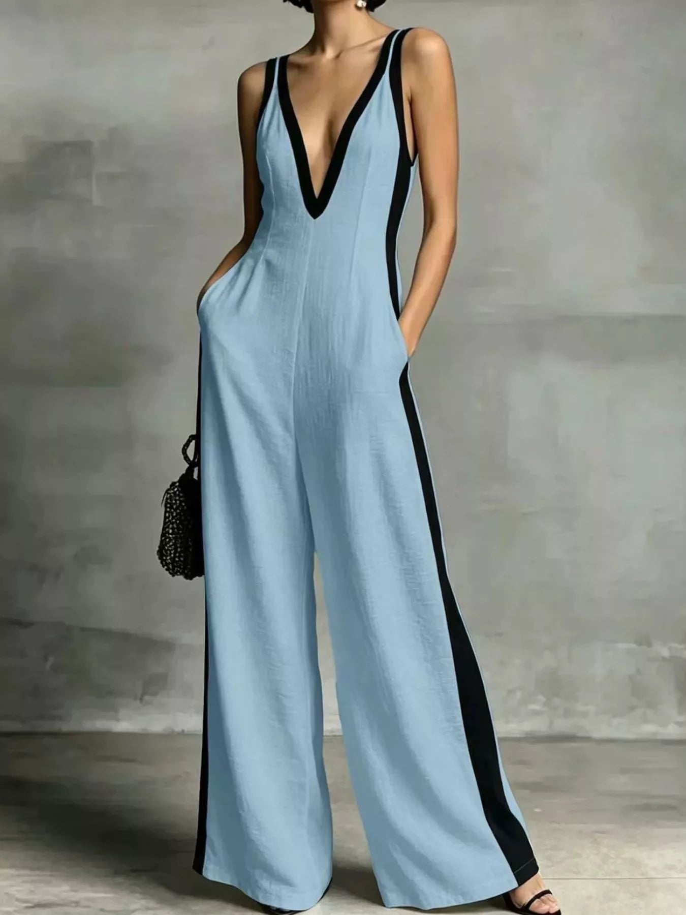 Light blue deep V-neck wide-leg jumpsuit with black contrast trim, sleeveless