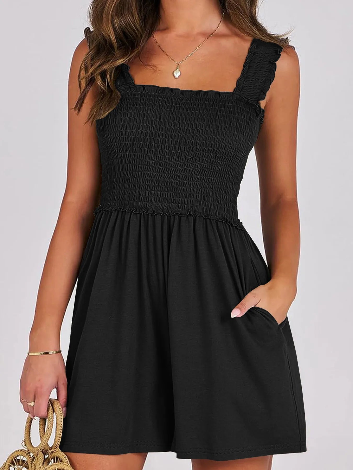 Black smocked square-neck summer romper with sleeveless ruffled straps and gathered skirt