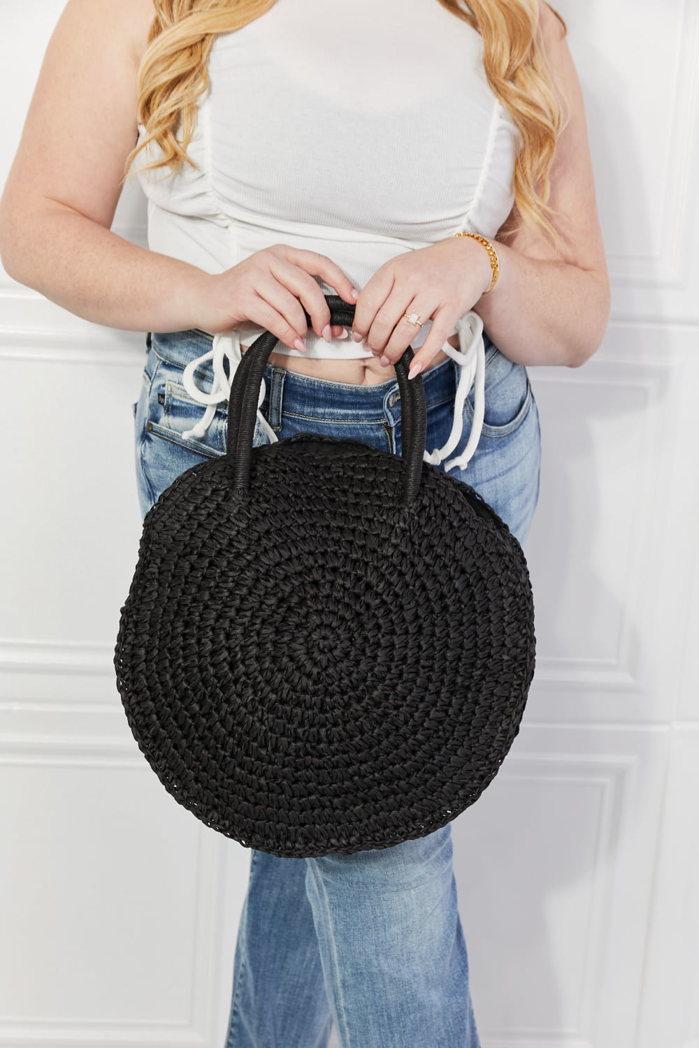 Black round woven straw rattan handbag with braided top handles, open top