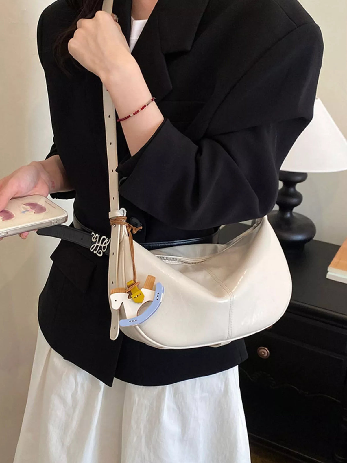 Medium ivory vegan leather shoulder bag with zipper top and hanging charm