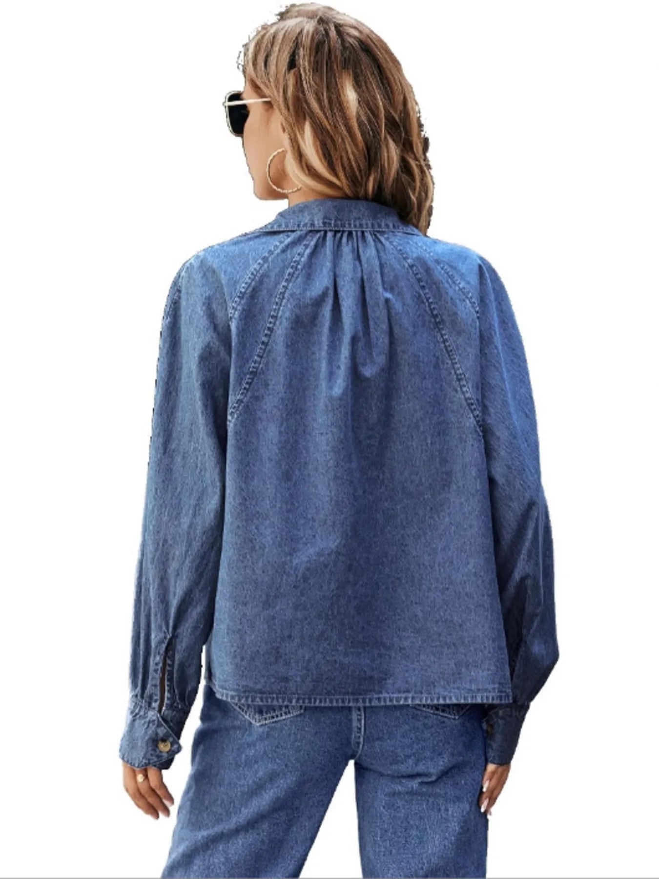 Blue denim button-up long sleeve shirt, back view with yoke seam and pointed collar