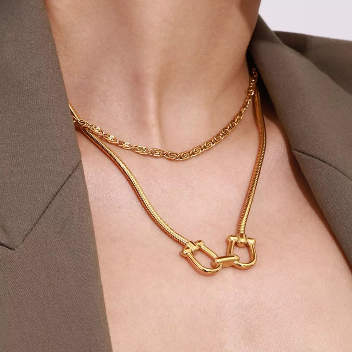 Gold-plated horseshoe necklace with curb chain and linked U-shaped pendant centerpiece
