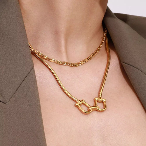 Gold-plated horseshoe necklace with curb chain and linked U-shaped pendant centerpiece