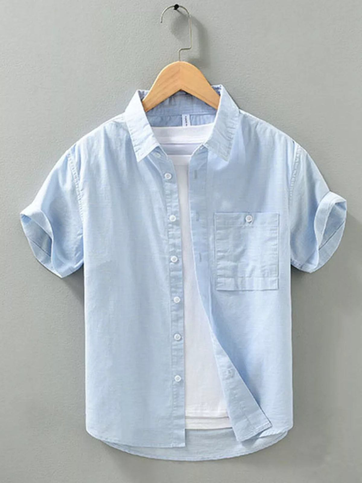 Light blue men’s short-sleeve button shirt with chest pocket and button front