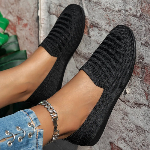 Black knit slip-on loafers with stitched stripe pattern and textured rubber sole