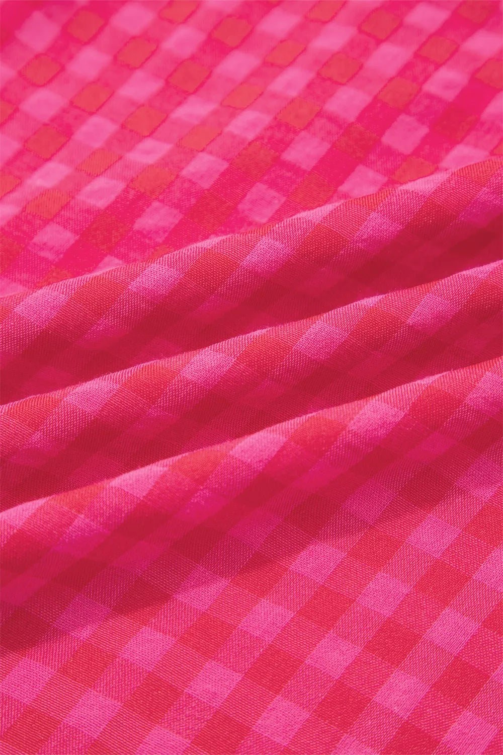 Deep rose checkered woven fabric close-up showing fine grid pattern and texture