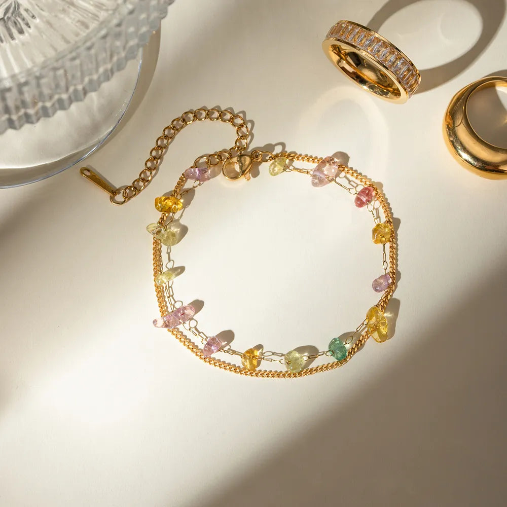 Gold chain and multicolor stone-bead bracelet with dangling charms