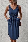 Sleeveless V-neck curved-hem dress in dark blue, gathered waist and drawstring.
