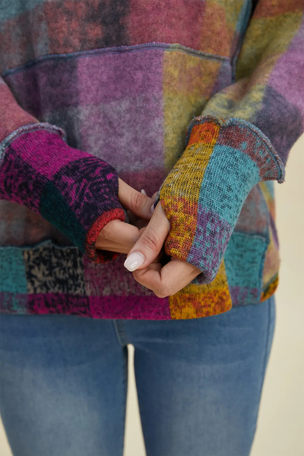 Plaid fleece hoodie cuff close-up with multicolor stripe edging and textured fabric