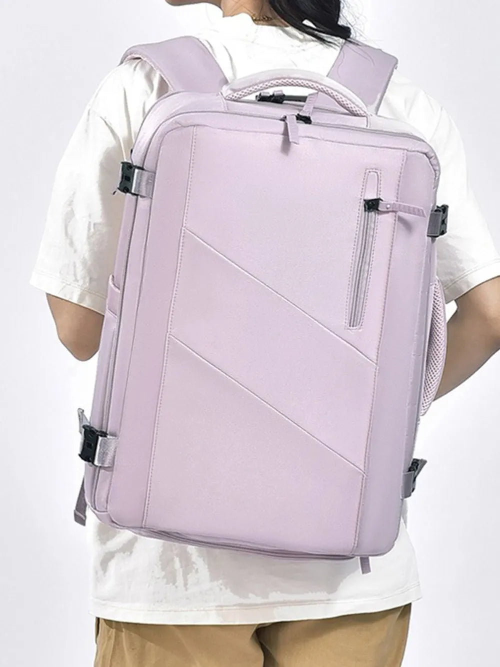 Lilac backpack bag worn on shoulders with front diagonal panel and zip pocket