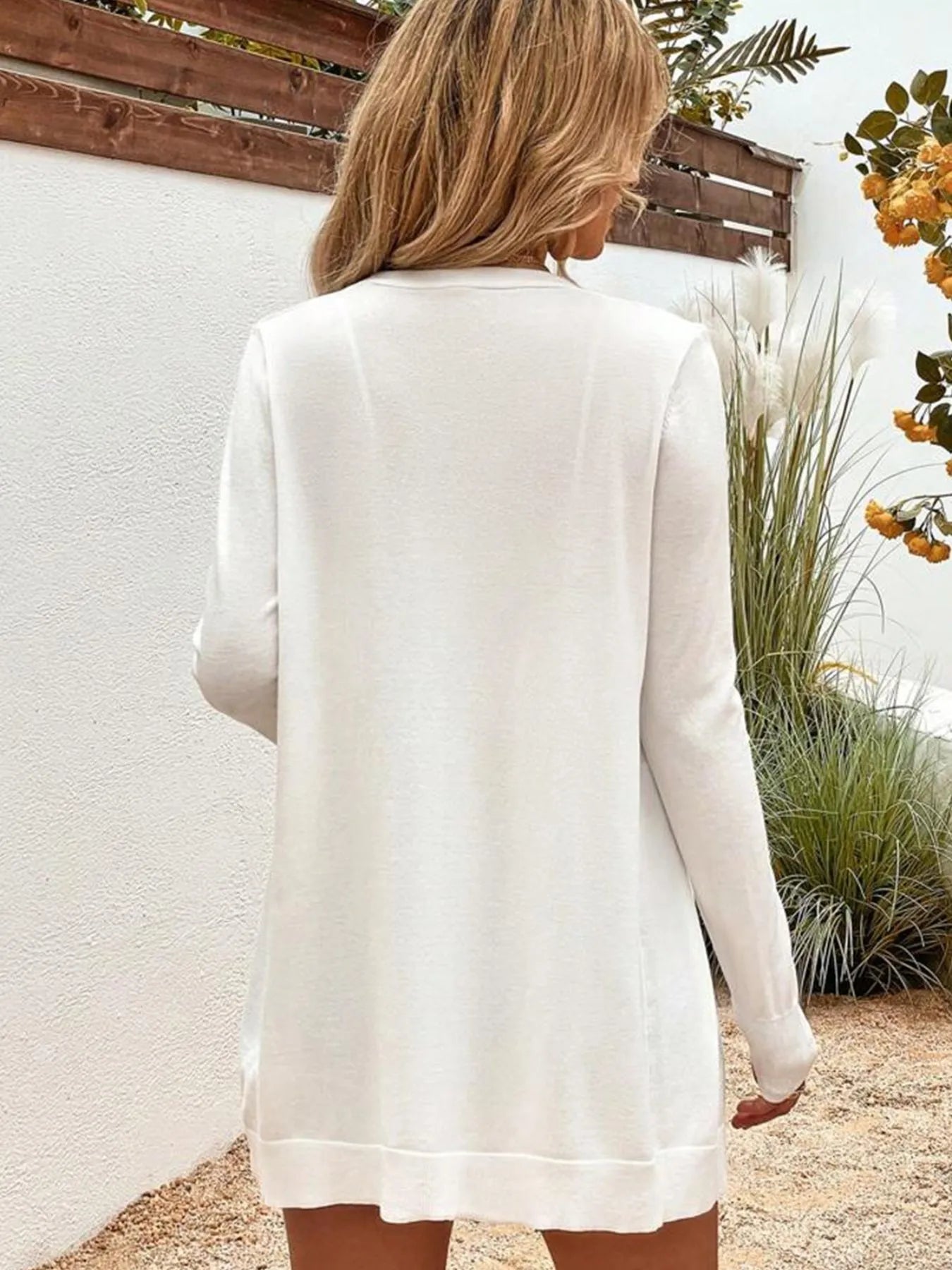 White open-front cardigan with long sleeves, back view drape and hem visible